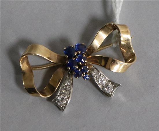 A gold, sapphire and diamond set bow brooch. 34mm.